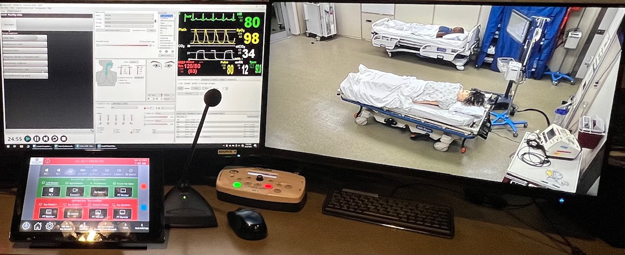 Simulation control station with vital signs monitoring and live camera feed