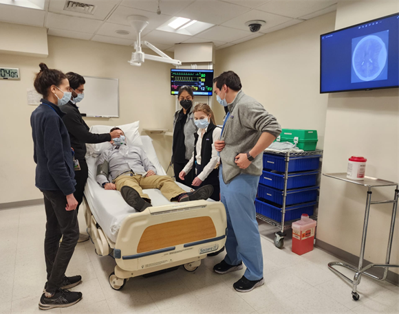 Team simulation training with brain CT